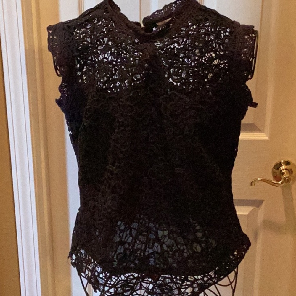Blue lace blouse with blue slip underneath.